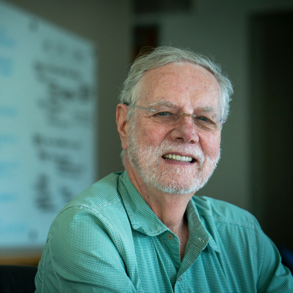 This image features Ron Davis, PhD with a beard and glasses wearing a green shirt.