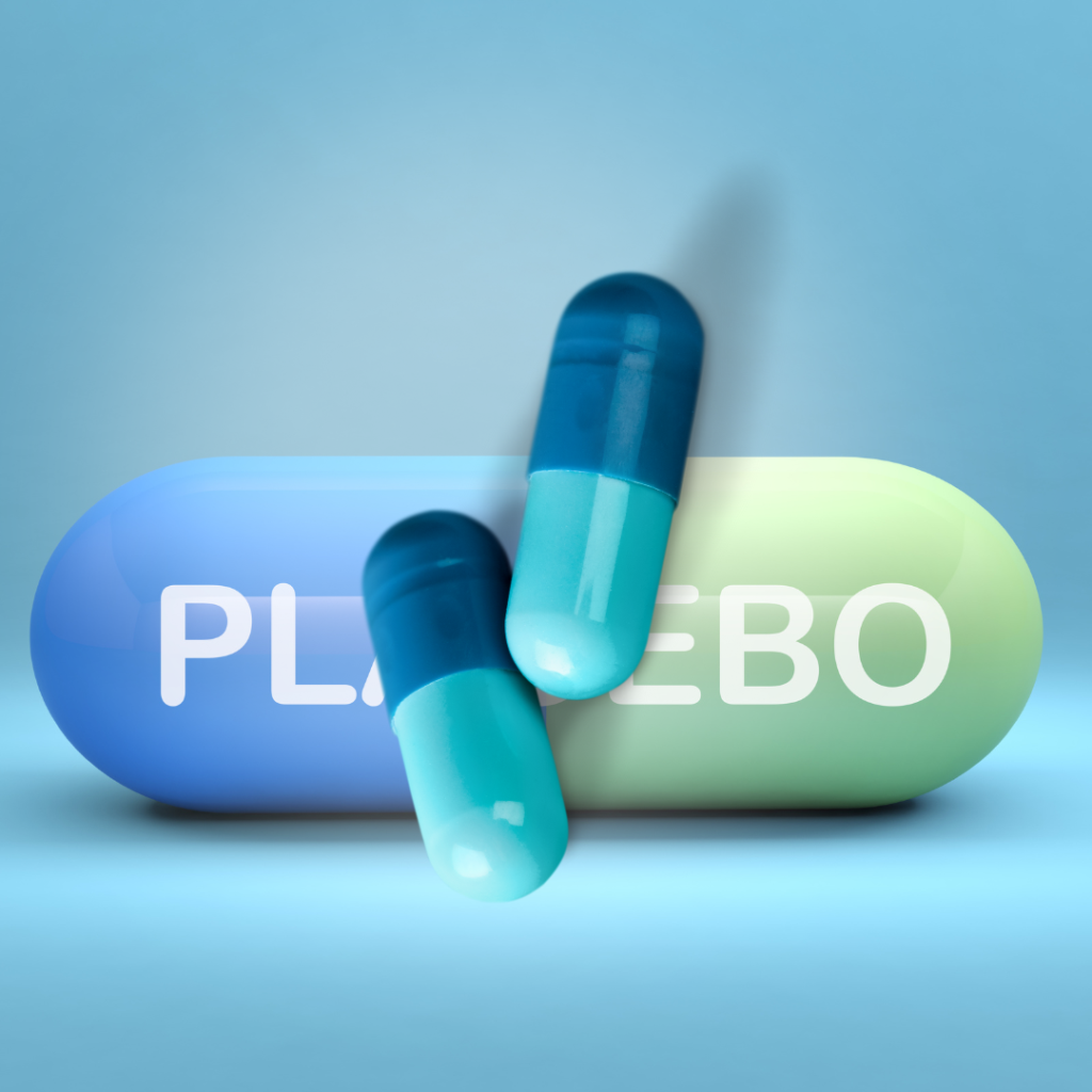 The image shows two blue and teal capsules resting on a large, glossy pill-shaped object divided into blue and green halves. The word "PLACEBO" is written in bold white letters across the large pill.